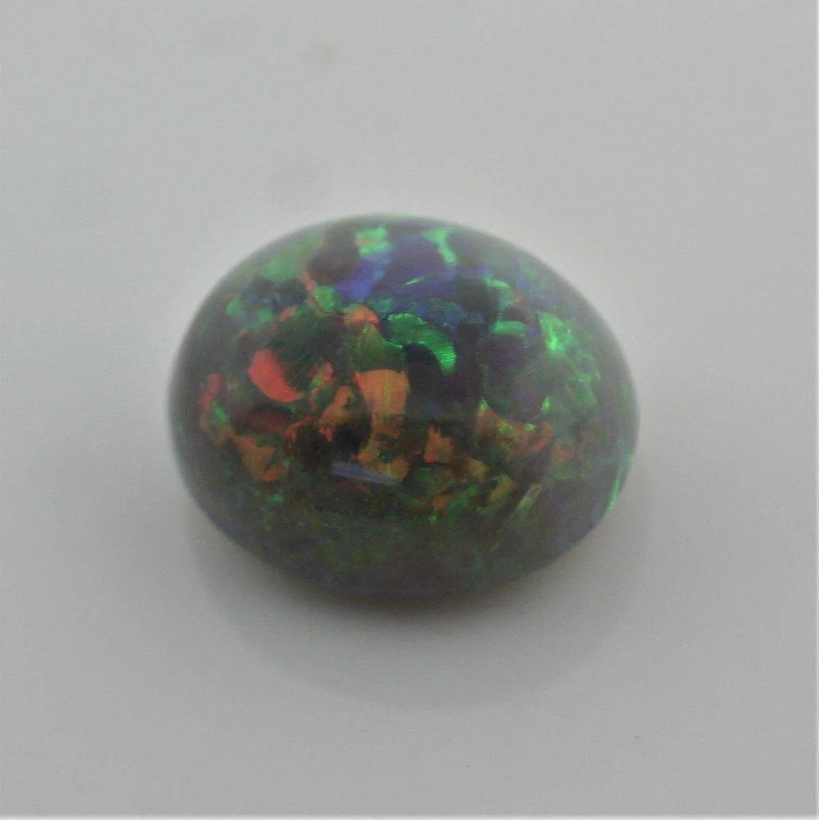 4.67 carat Australian Dark Opal Cabochon Play of Color Green-Orange Blue Tone